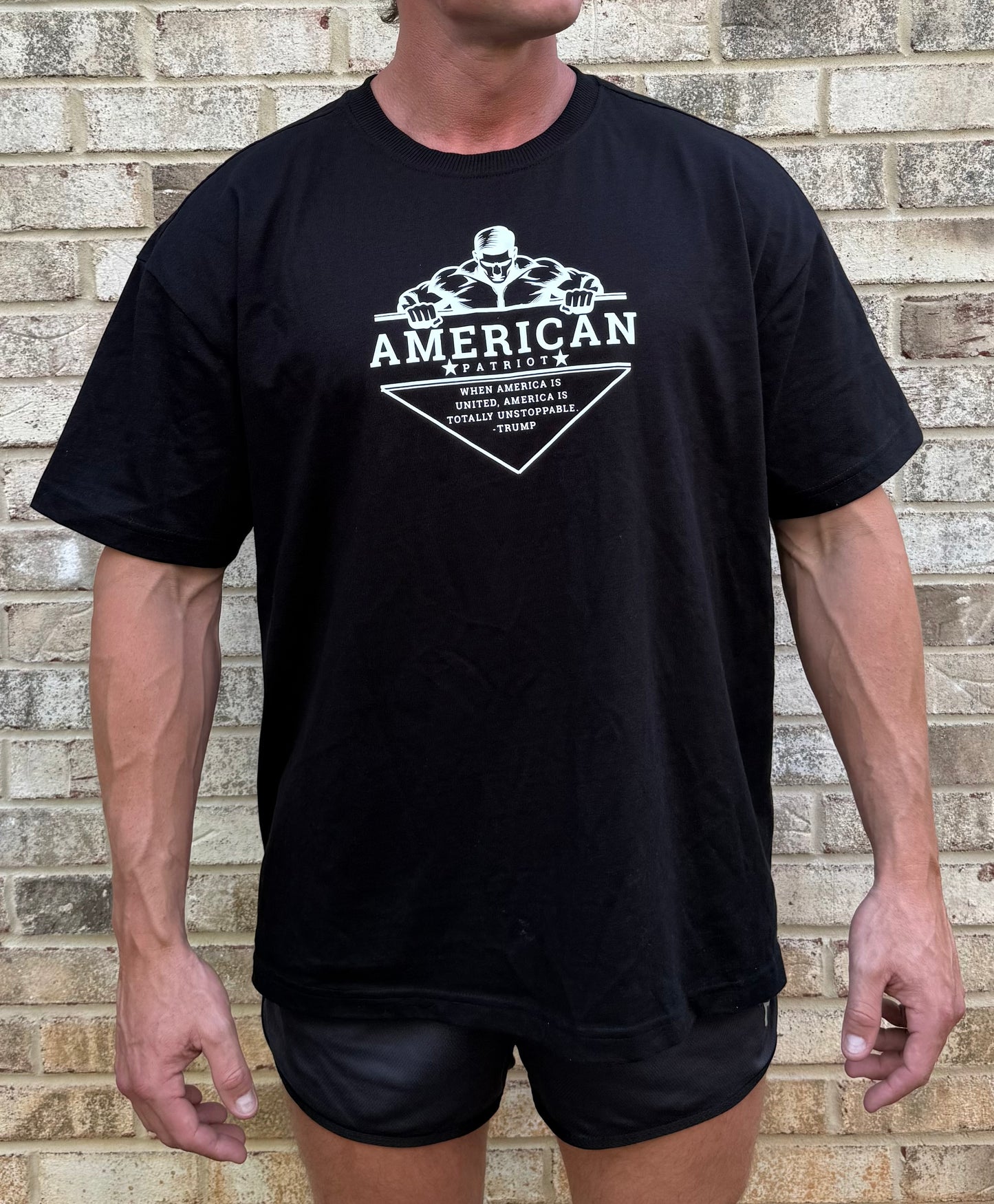 Unstoppable America Heavyweight Oversized T-Shirt – Black | Patriotic Gym Tee for Men | Bodybuilder Graphic with Donald Trump Quote